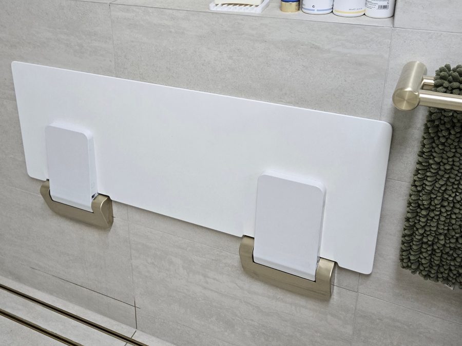 Rails and a fold-down seat installed in a residential bathroom